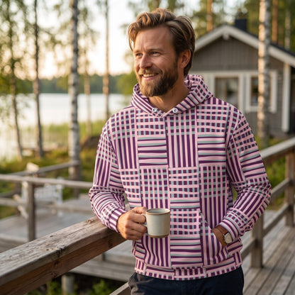 Good Wishes 365 recycled hoodie with purple and blue geometric stripes worn by a man on a wooden deck at sunset.