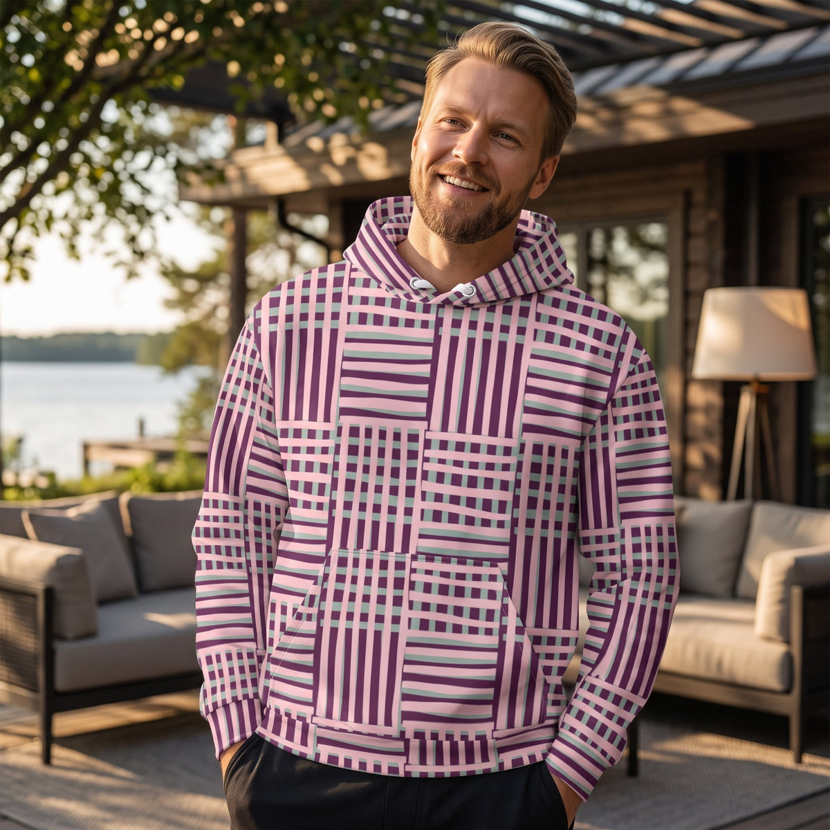 Good Wishes 365 recycled hoodie with purple and blue geometric stripes worn by a smiling man on a patio.