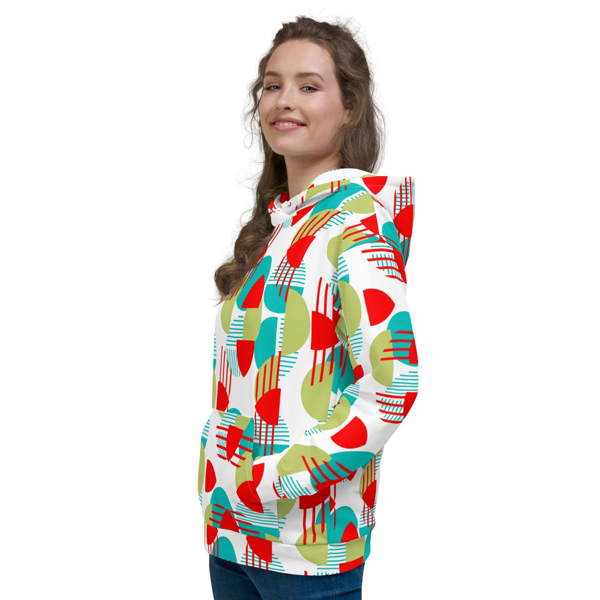 Woman wearing a Good Wishes 365 recycled hoodie with a vibrant red, green, and teal geometric all-over print pattern.