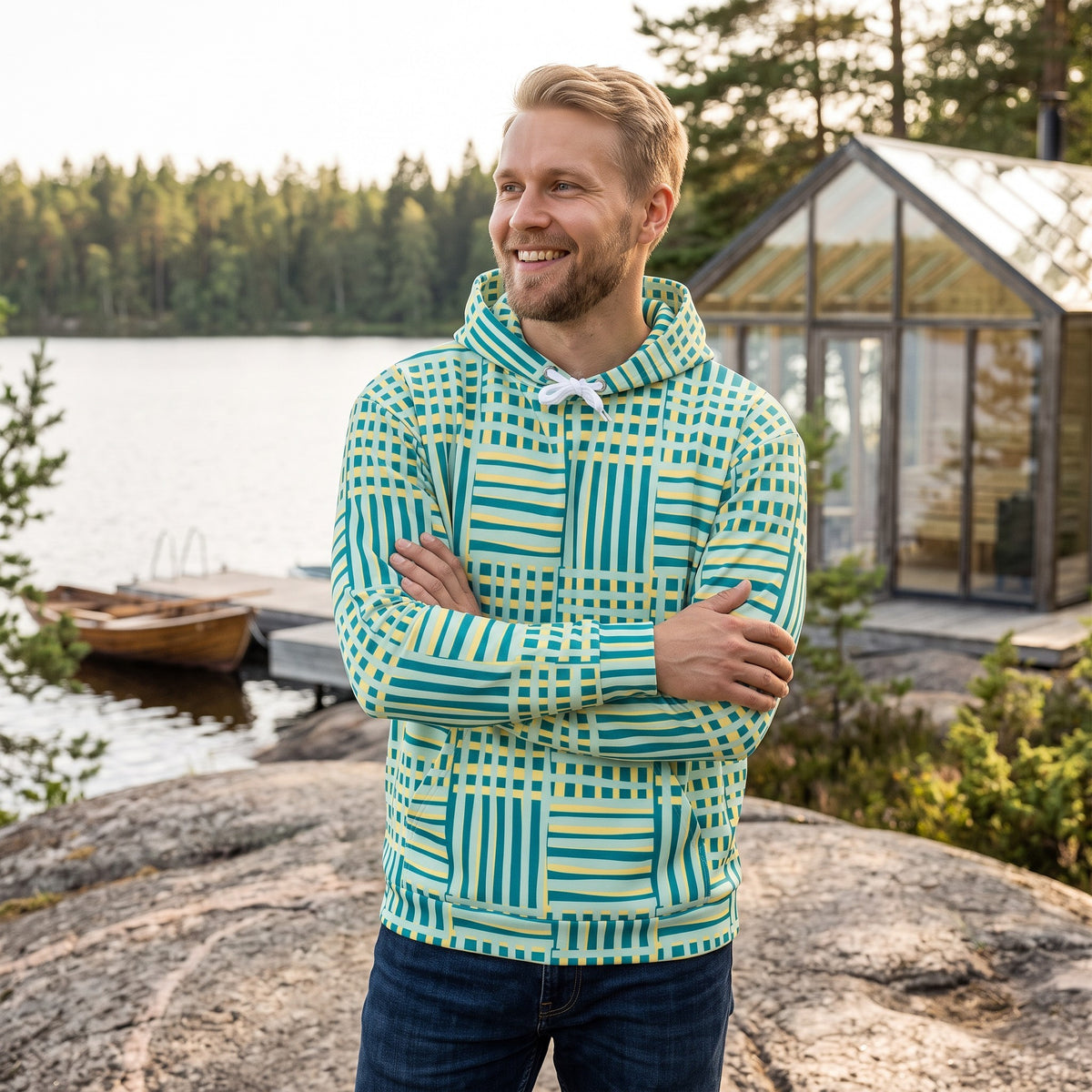 Good Wishes 365 recycled hoodie with blue and yellow geometric stripes worn by a man standing by a lake