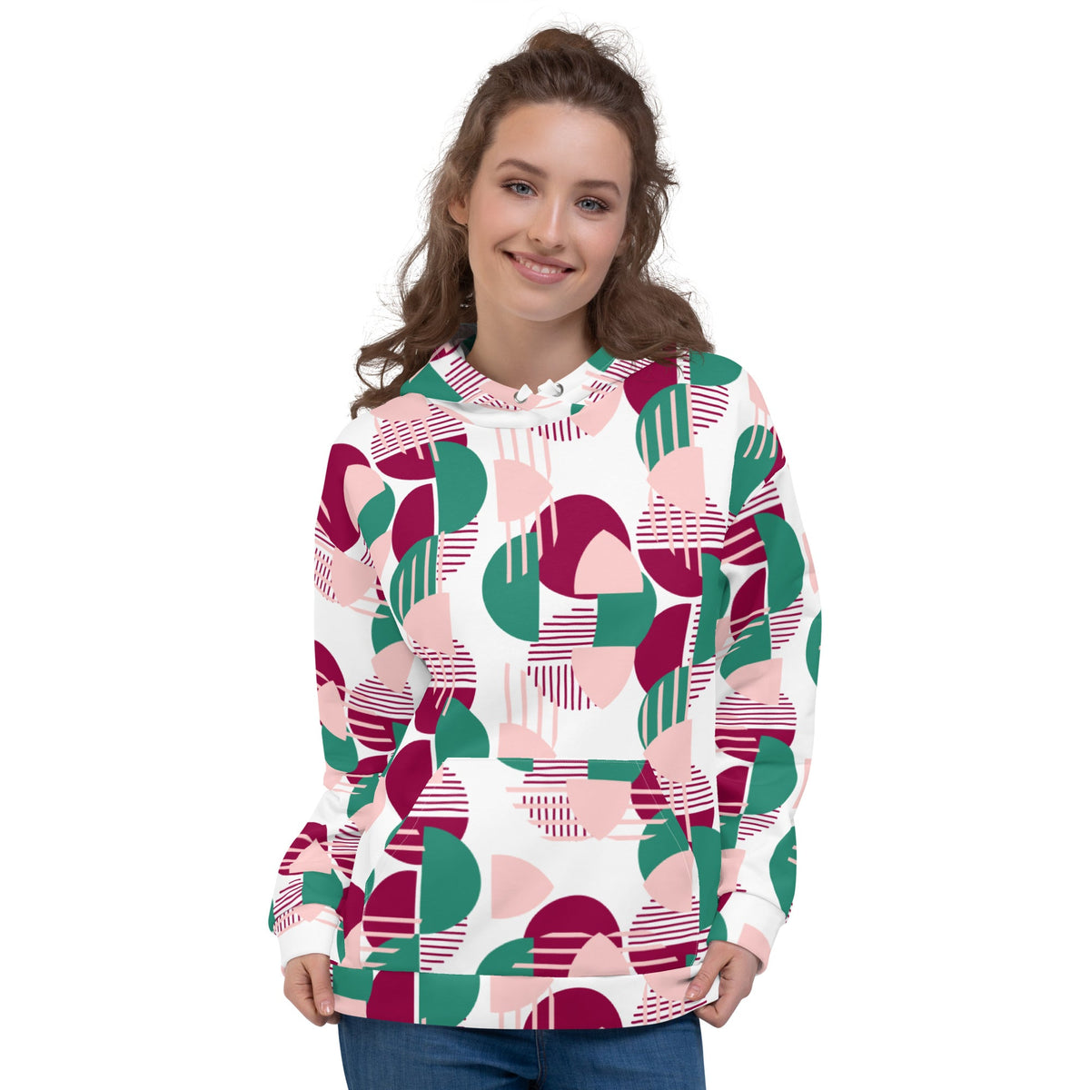 Woman wearing a Good Wishes 365 recycled hoodie with a pink, burgundy, and green geometric all-over print