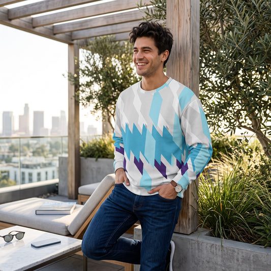 Good Wishes 365 unisex sweatshirt with blue and purple geometric print worn by a smiling man on a sunny rooftop