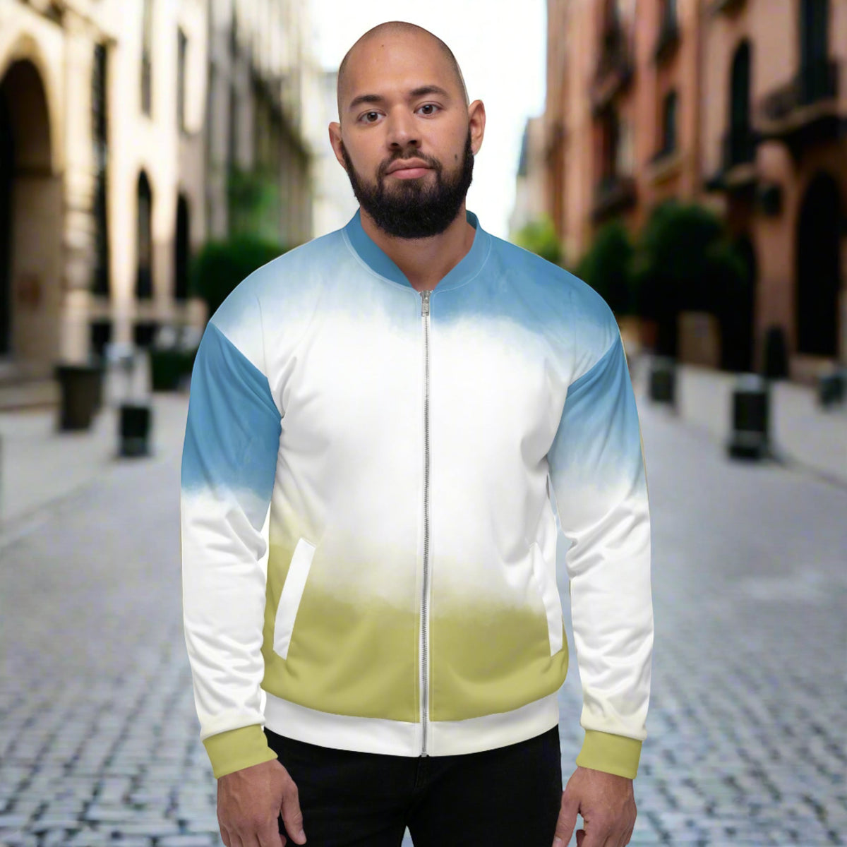 Good Wishes 365 unisex bomber jacket with a sky blue to grass green gradient print, worn by a man on a city street.