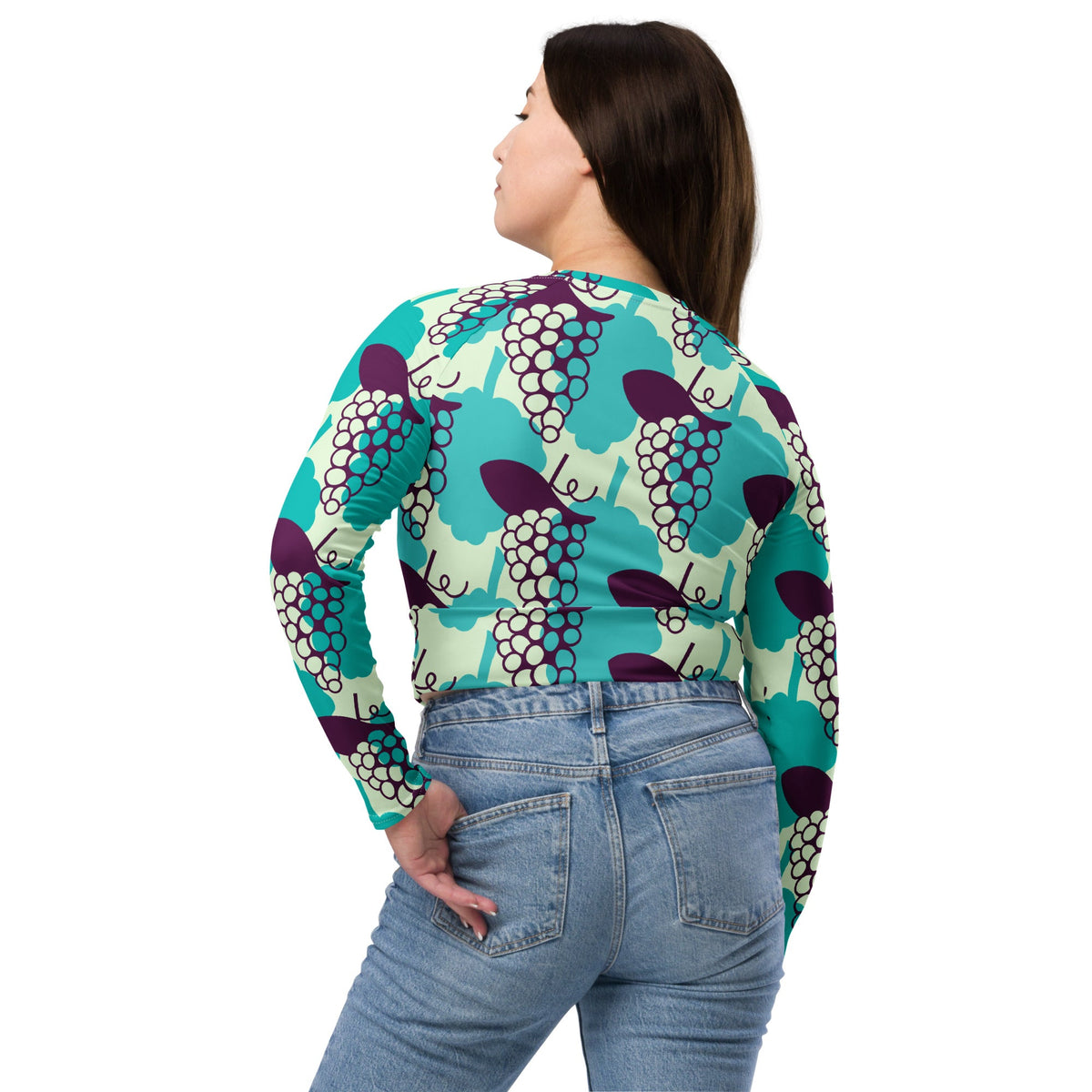 Good Wishes 365 long-sleeve crop top with a vibrant grape pattern, featuring UPF 50+ recycled fabric and raglan sleeves.