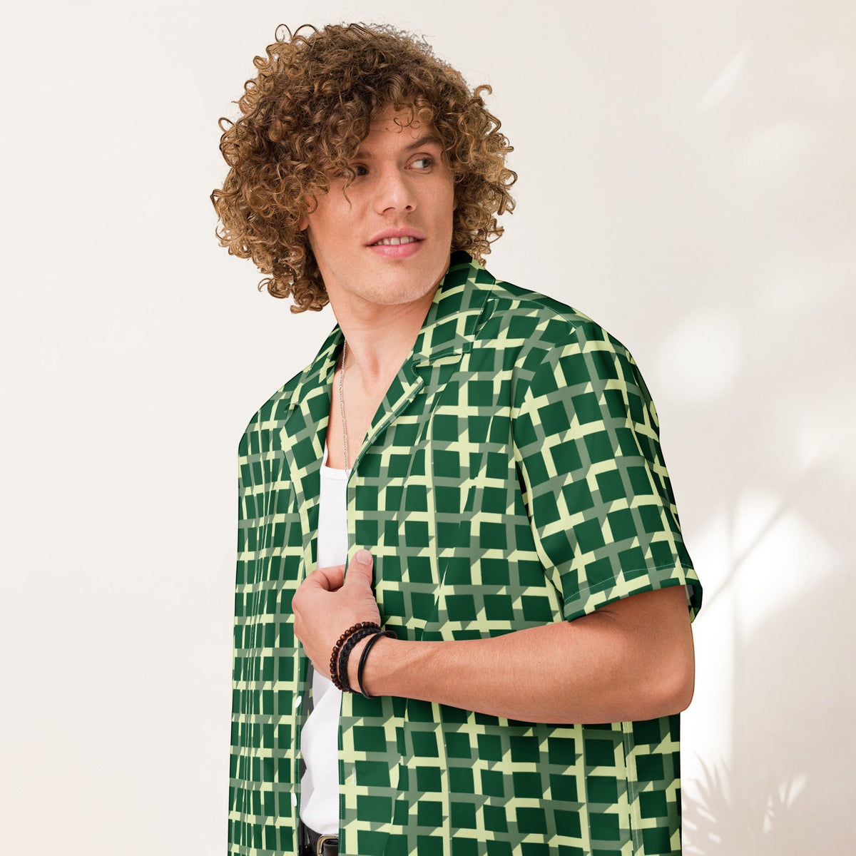 Good Wishes 365 men's green geometric checkered short sleeve button-down shirt worn by a man with curly hair