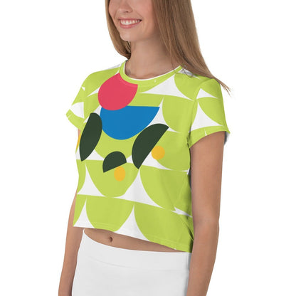 Good Wishes 365 lime green crop tee with abstract geometric mushroom graphic in pink, blue, and forest green.