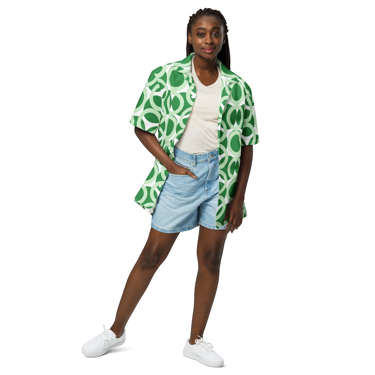 Good Wishes 365 unisex short sleeve button shirt in green and white retro geometric print worn over a white top.