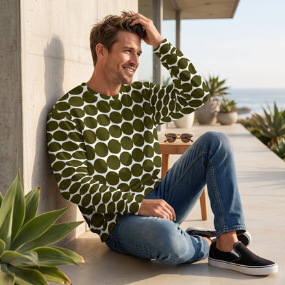 Good Wishes 365 unisex sweatshirt in green and white pebble dot print worn by a man sitting on a modern patio
