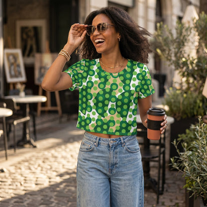 Good Wishes 365 crop tee with green and beige polka dot print worn by a smiling woman in a sunny outdoor cafe setting.