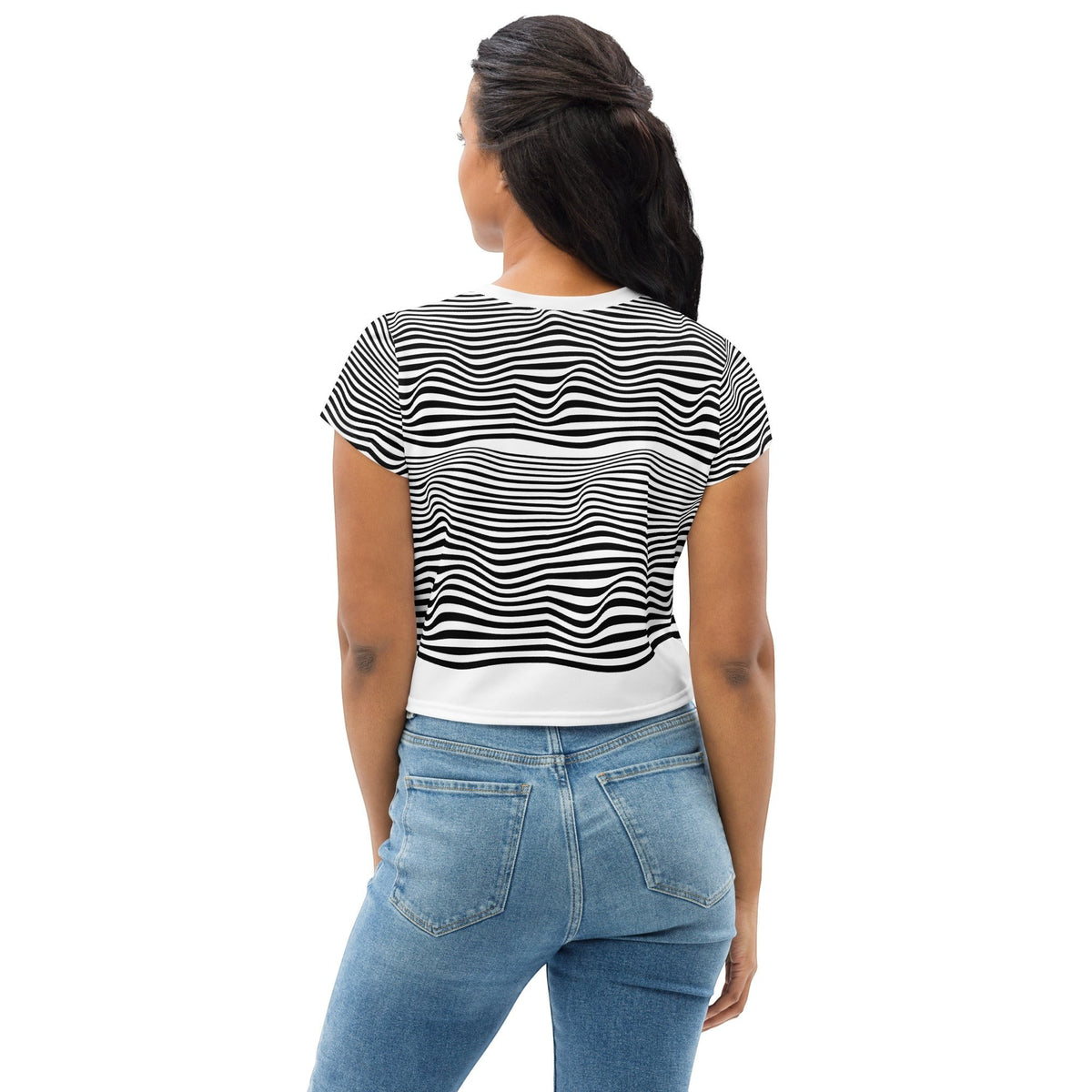 Good Wishes 365 crop tee with black and white wavy line print worn by a woman from the back view with blue jeans
