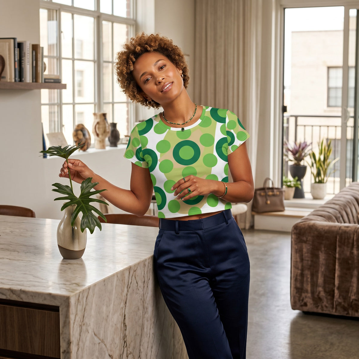 Good Wishes 365 kelly green retro mod polka dot crop tee worn by a woman in a bright, modern living room.