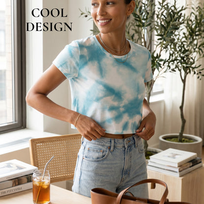 Good Wishes 365 light blue tie-dye crop tee worn by a smiling woman in a bright, modern interior.