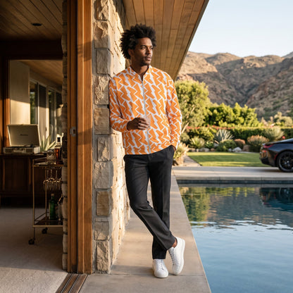 Good Wishes 365 unisex bomber jacket with orange and white lightning bolt print, worn by a man by a pool.