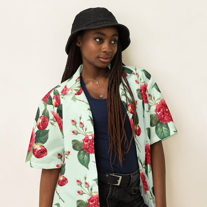 Good Wishes 365 mint green short sleeve button shirt with red rose floral print worn open over a navy tank top