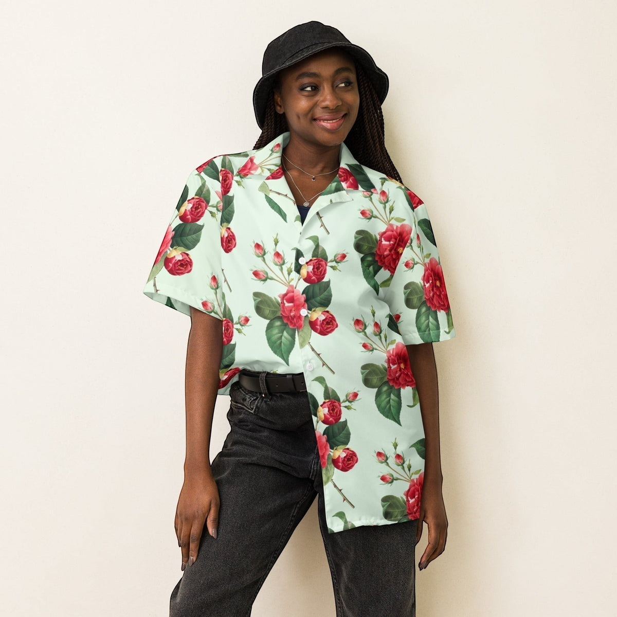 Good Wishes 365 mint green short sleeve button shirt with red rose floral print worn by a woman in a black bucket hat.