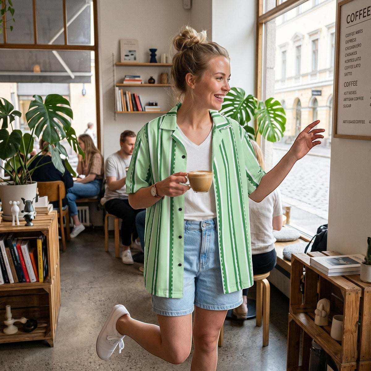 Good Wishes 365 pastel mint striped short-sleeve button-down shirt with UPF50+ protection worn by a woman in a cafe.
