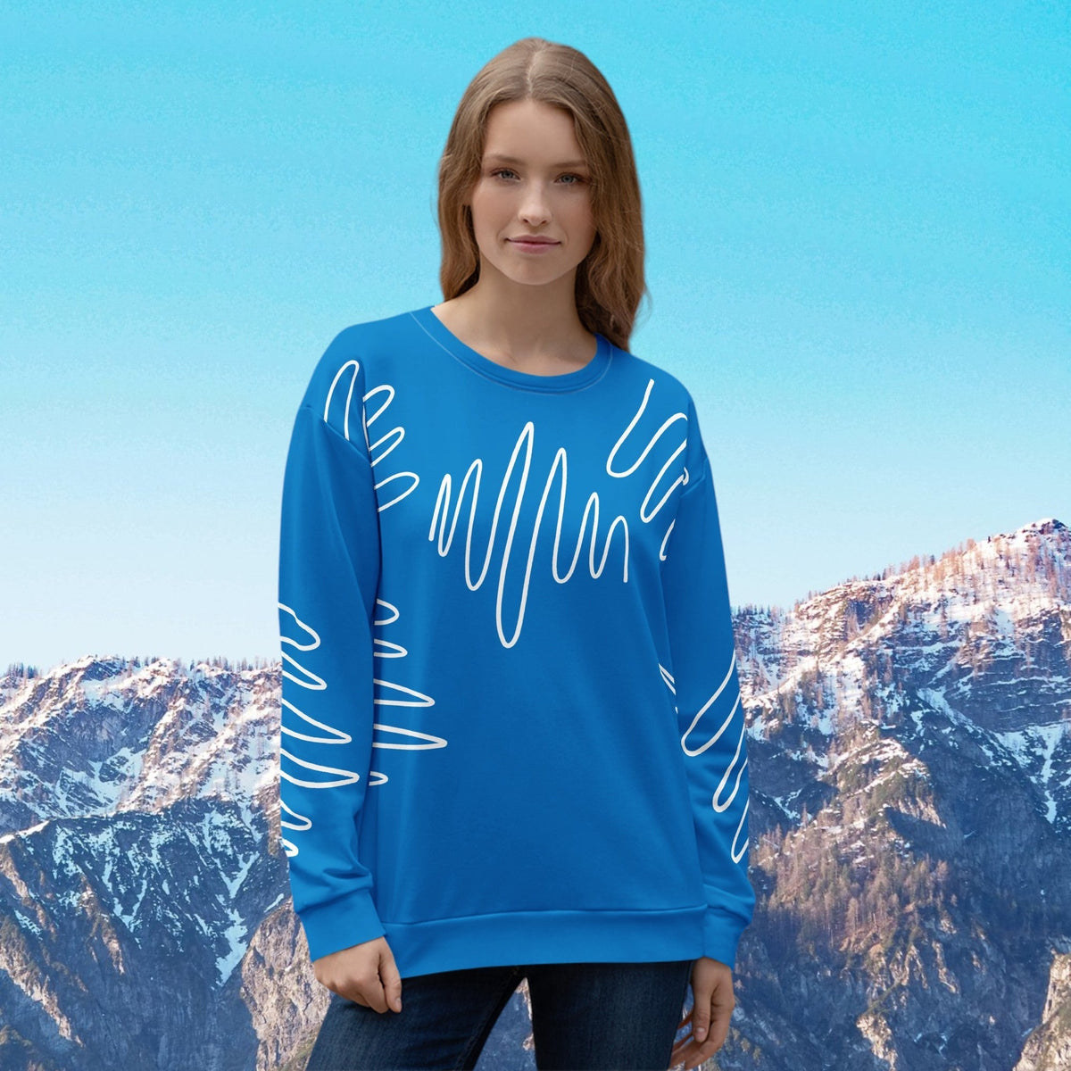 Good Wishes 365 navy blue recycled sweatshirt with white abstract scribble lines worn by a woman against mountains.