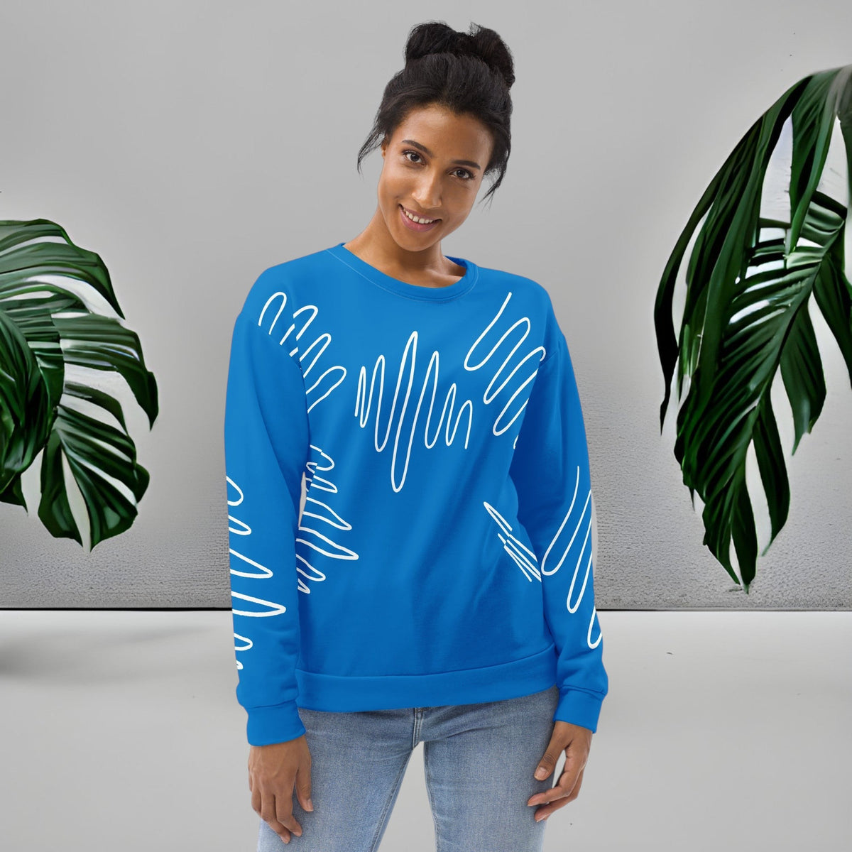 Woman wearing a Good Wishes 365 navy blue recycled sweatshirt with white abstract scribble lines and ribbed cuffs.