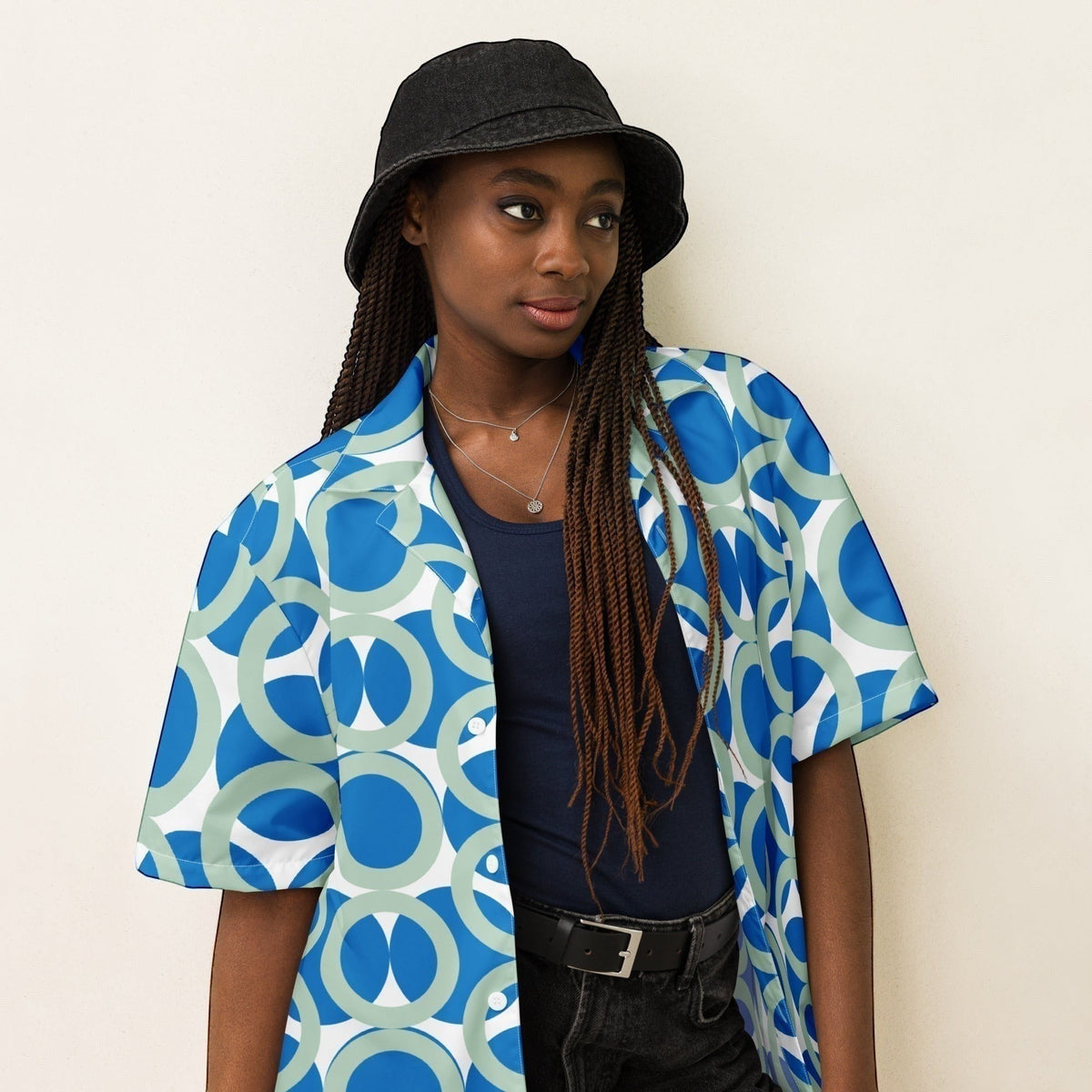 Good Wishes 365 navy blue retro geometric print short sleeve button shirt worn by a model in a black bucket hat.