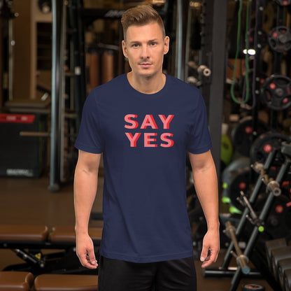 Good Wishes 365 unisex navy crew neck t-shirt with coral Say Yes graphic text worn by a man in a gym