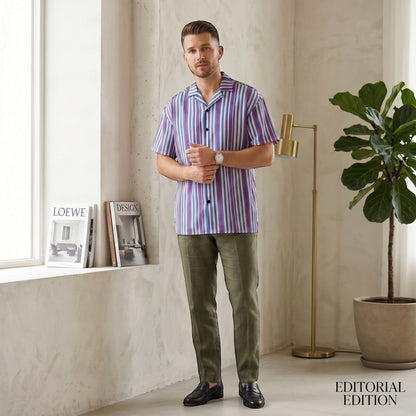 Good Wishes 365 navy blue striped short sleeve button shirt with magenta accents worn by a man in a modern room