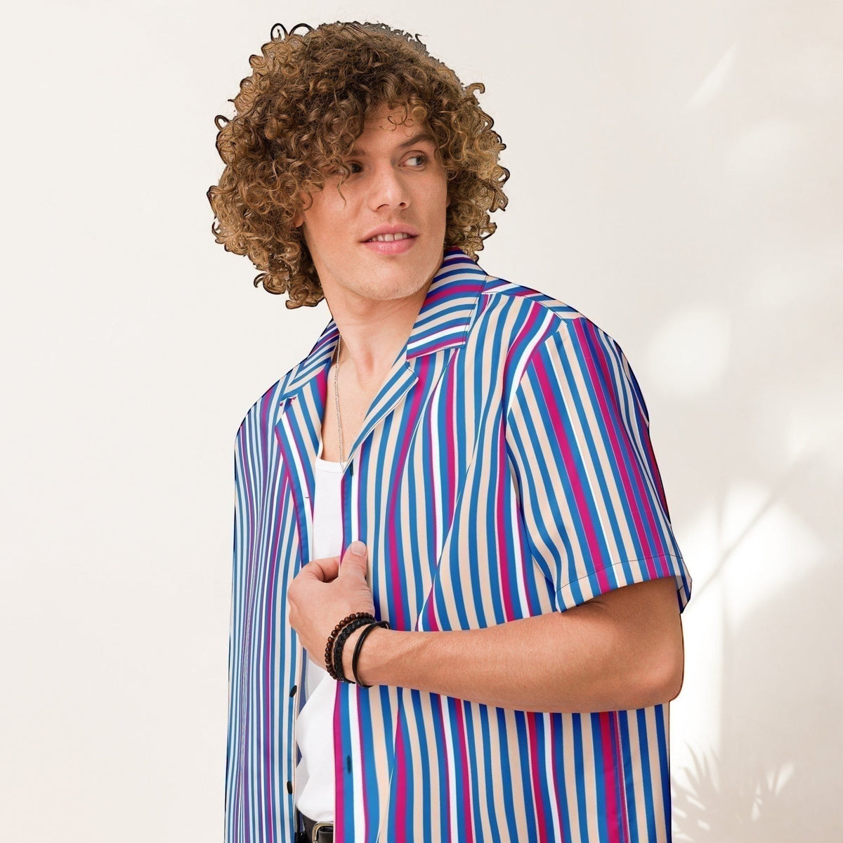Good Wishes 365 navy blue striped short sleeve button shirt with magenta and white accents on a curly-haired model.