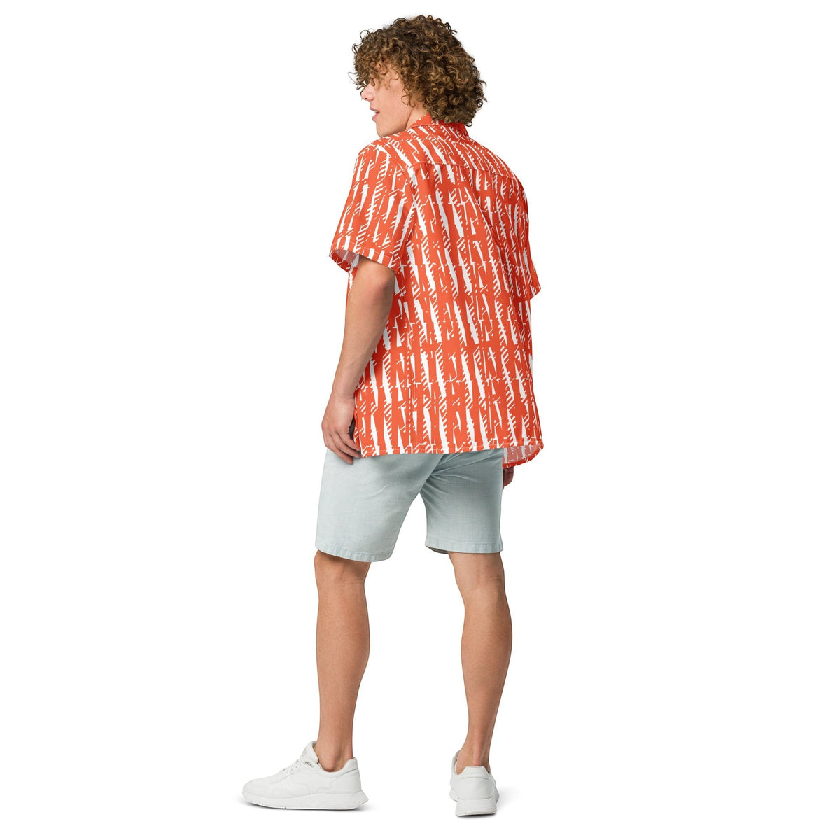Good Wishes 365 unisex button shirt in orange and white abstract print, worn with light grey shorts by a curly-haired man