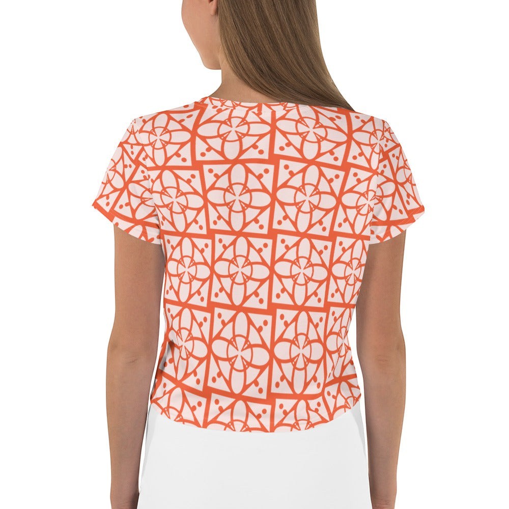 Good Wishes 365 orange and white geometric all-over print crop tee worn by a woman, back view.