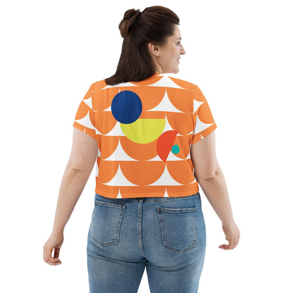 Good Wishes 365 orange crop tee with geometric mushroom graphic print worn by a woman from the back view