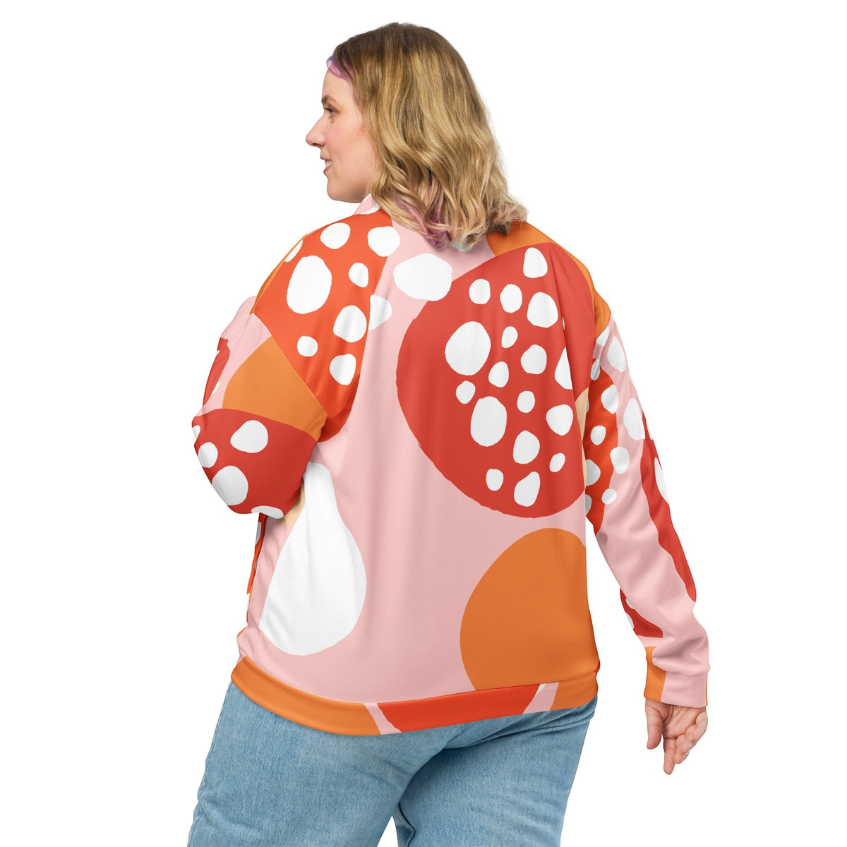 Good Wishes 365 unisex bomber jacket with orange and pink abstract strawberry print, worn by a woman from behind.