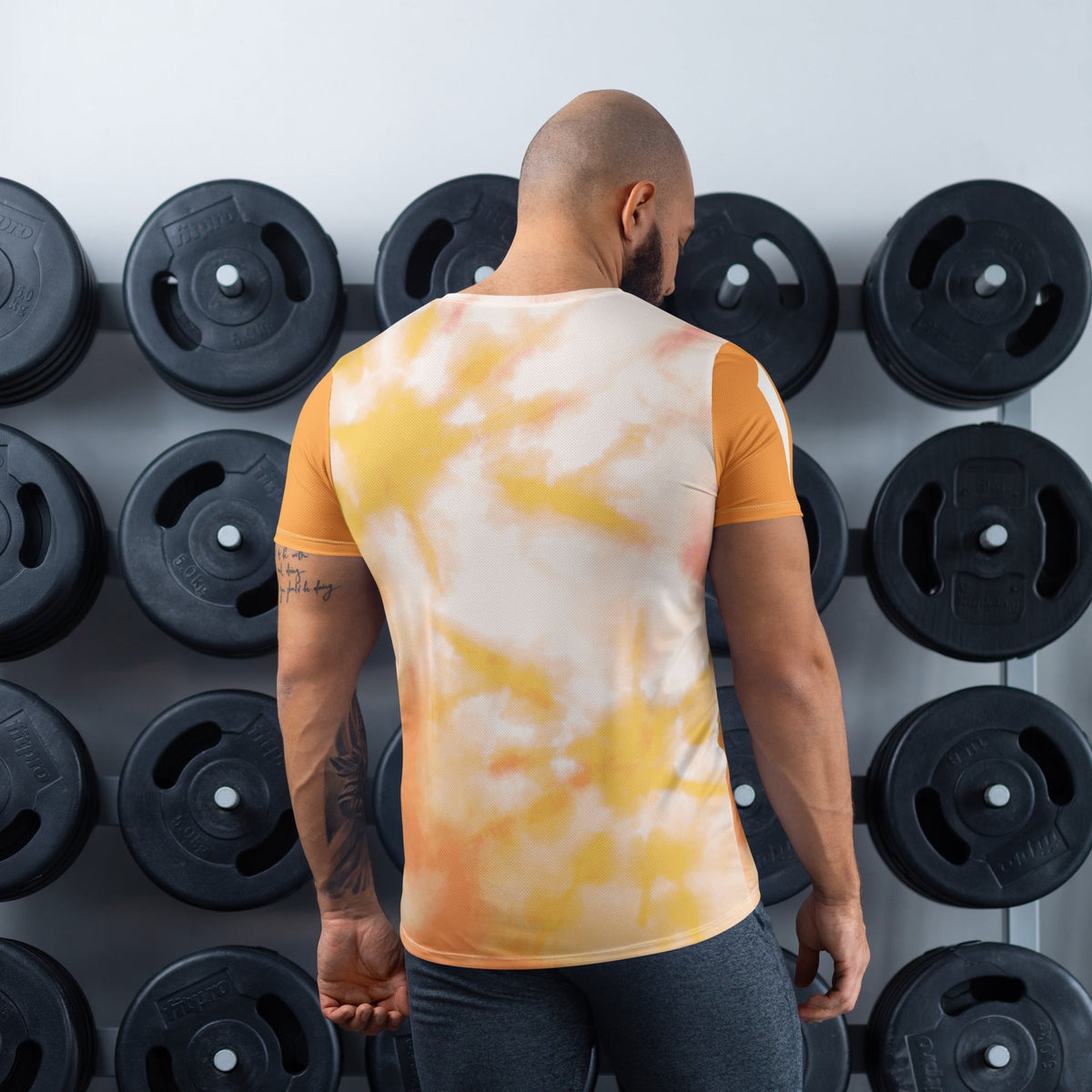 Good Wishes 365 men's orange and harvest gold tie-dye athletic t-shirt worn by a man in a gym setting