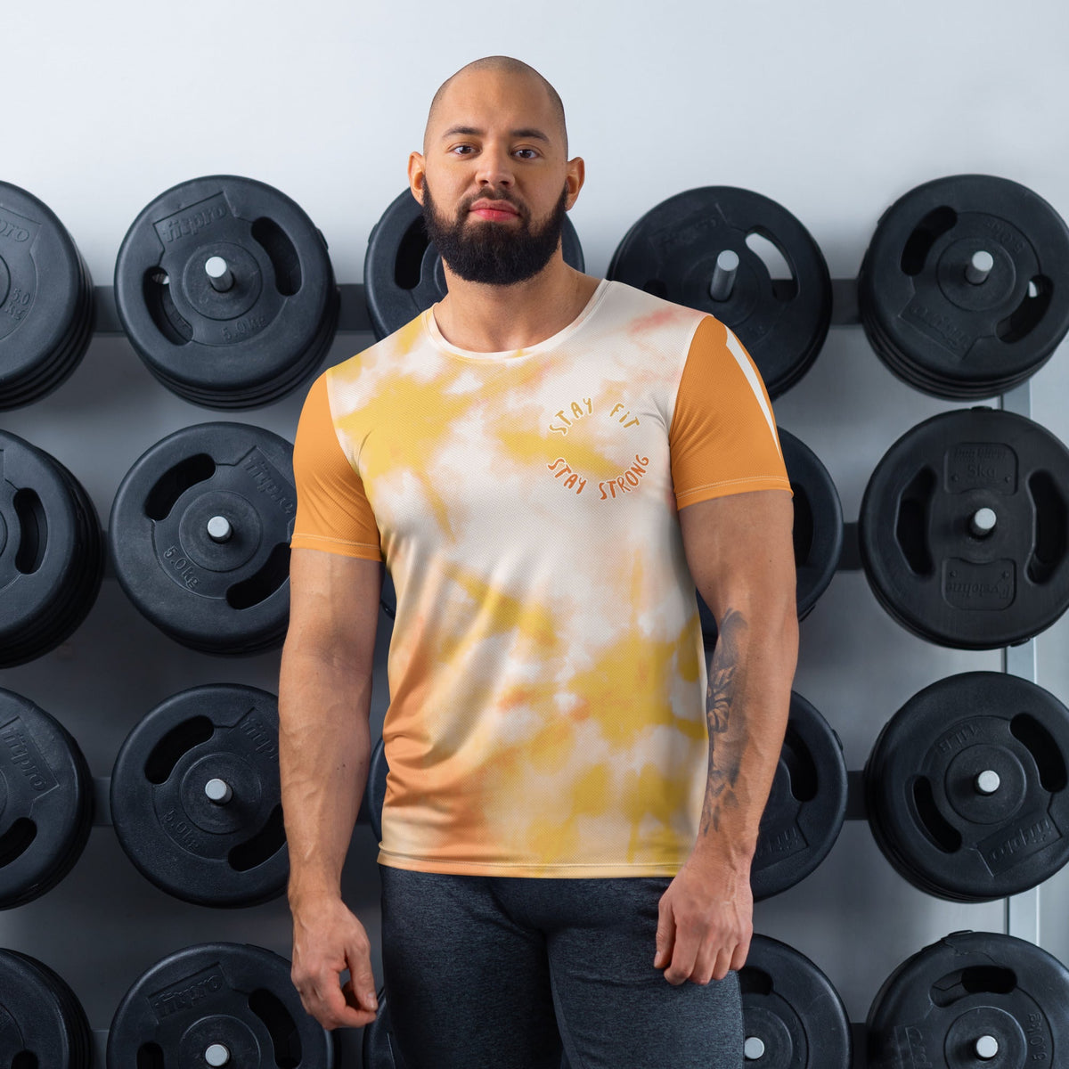 Good Wishes 365 men's orange and harvest gold tie-dye athletic t-shirt with Stay Fit Stay Strong graphic in a gym