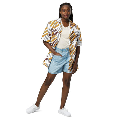 Good Wishes 365 unisex oversized button shirt with geometric print, worn by a model with denim shorts and white sneakers.