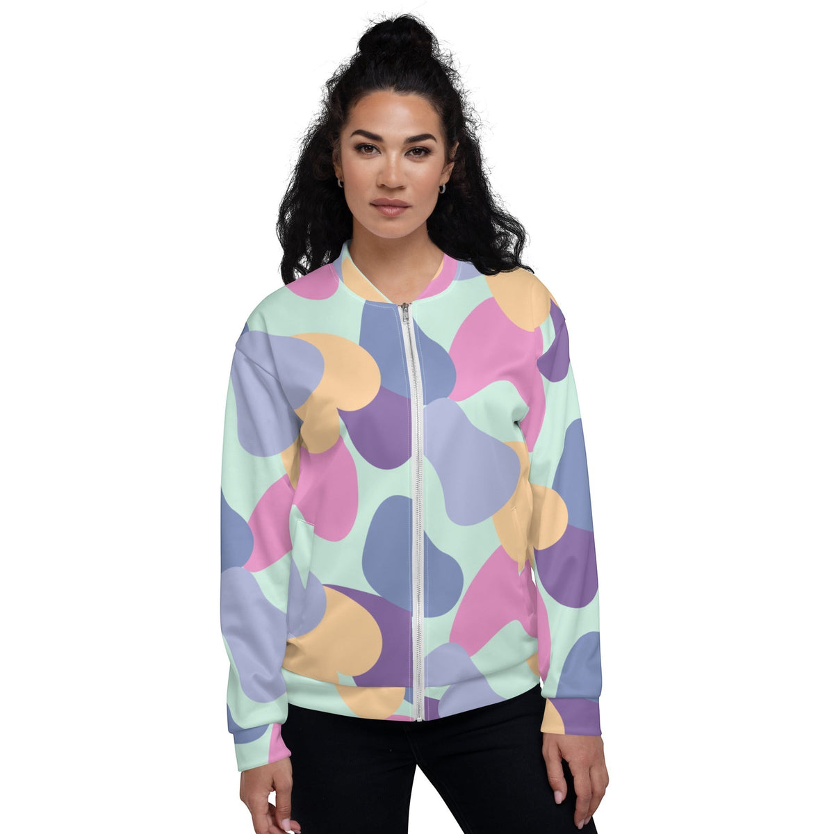 Woman wearing a Good Wishes 365 unisex bomber jacket with a vibrant pastel abstract print and ribbed collar.