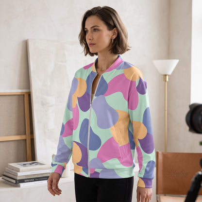 Good Wishes 365 unisex bomber jacket with pastel abstract print, silver zipper, and brushed fleece lining on a model.