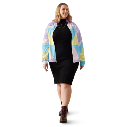 Good Wishes 365 unisex bomber jacket with pastel geometric print worn over a black ribbed dress by a smiling woman.