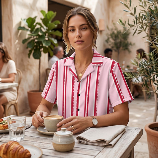 Good Wishes 365 retro pastel pink button shirt with red and white pixelated stripes worn by a woman at a cafe.