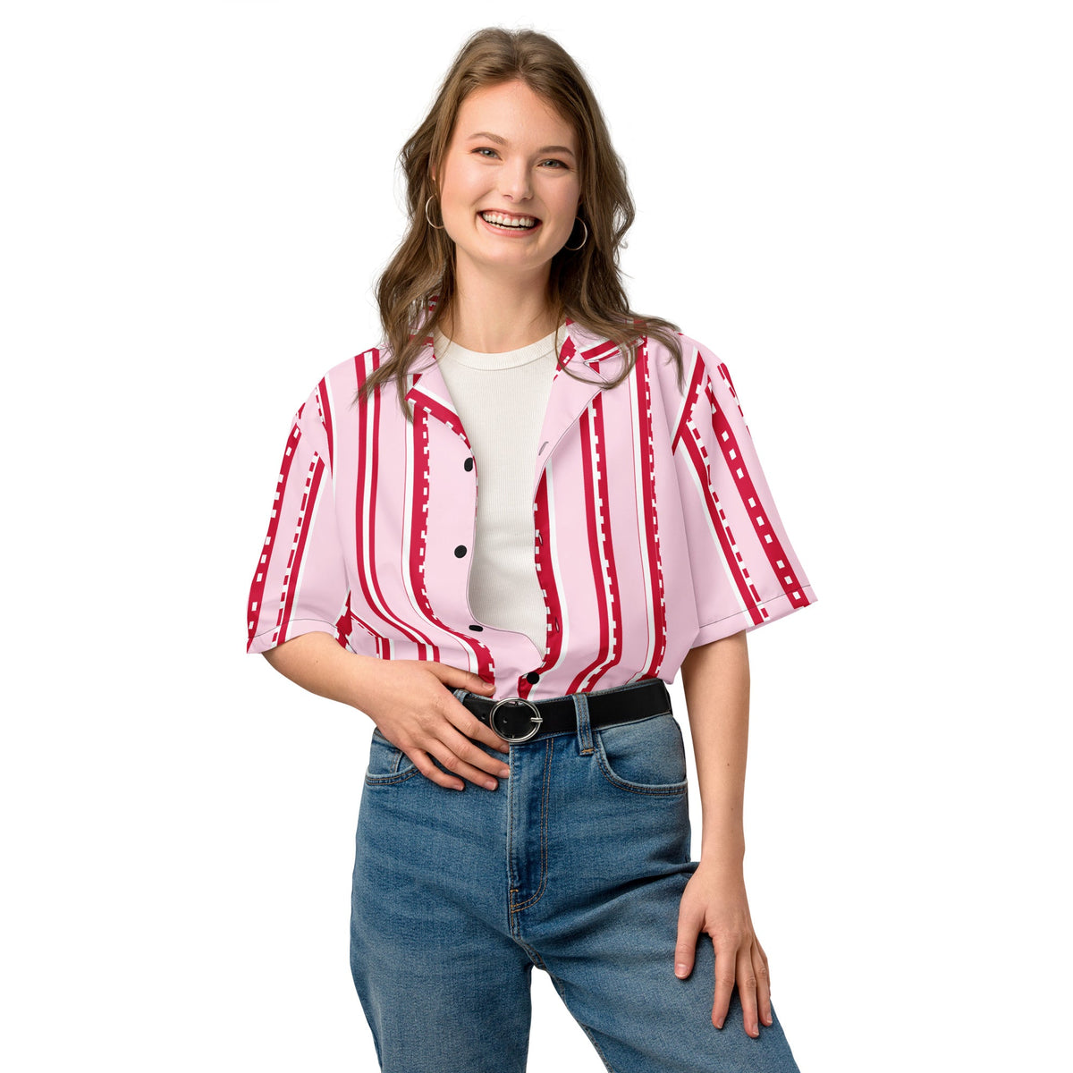 Good Wishes 365 unisex pastel pink button shirt with red pixelated stripes, worn by a smiling woman with blue jeans.