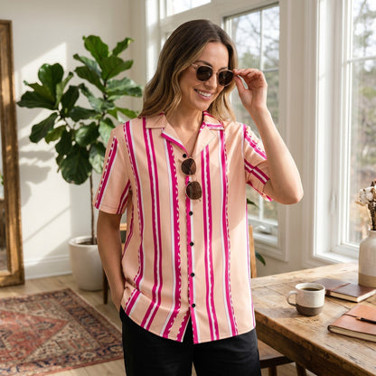 Good Wishes 365 retro pastel blush button shirt with magenta stripes, camp collar, and short sleeves on a woman.