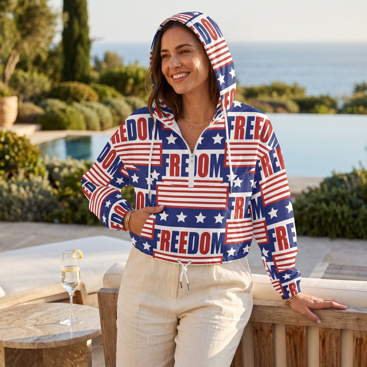 Good Wishes 365 women's cropped windbreaker with USA flag and FREEDOM print, featuring a hood and half-zip front.