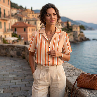 Good Wishes 365 retro pastel peach striped short sleeve button shirt with camp collar worn by a woman by the sea.