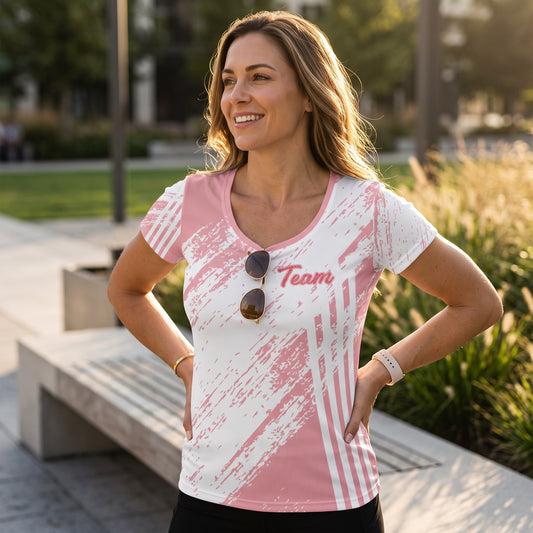 Good Wishes 365 women's pink and white abstract stripe athletic t-shirt with Team graphic worn by a smiling woman