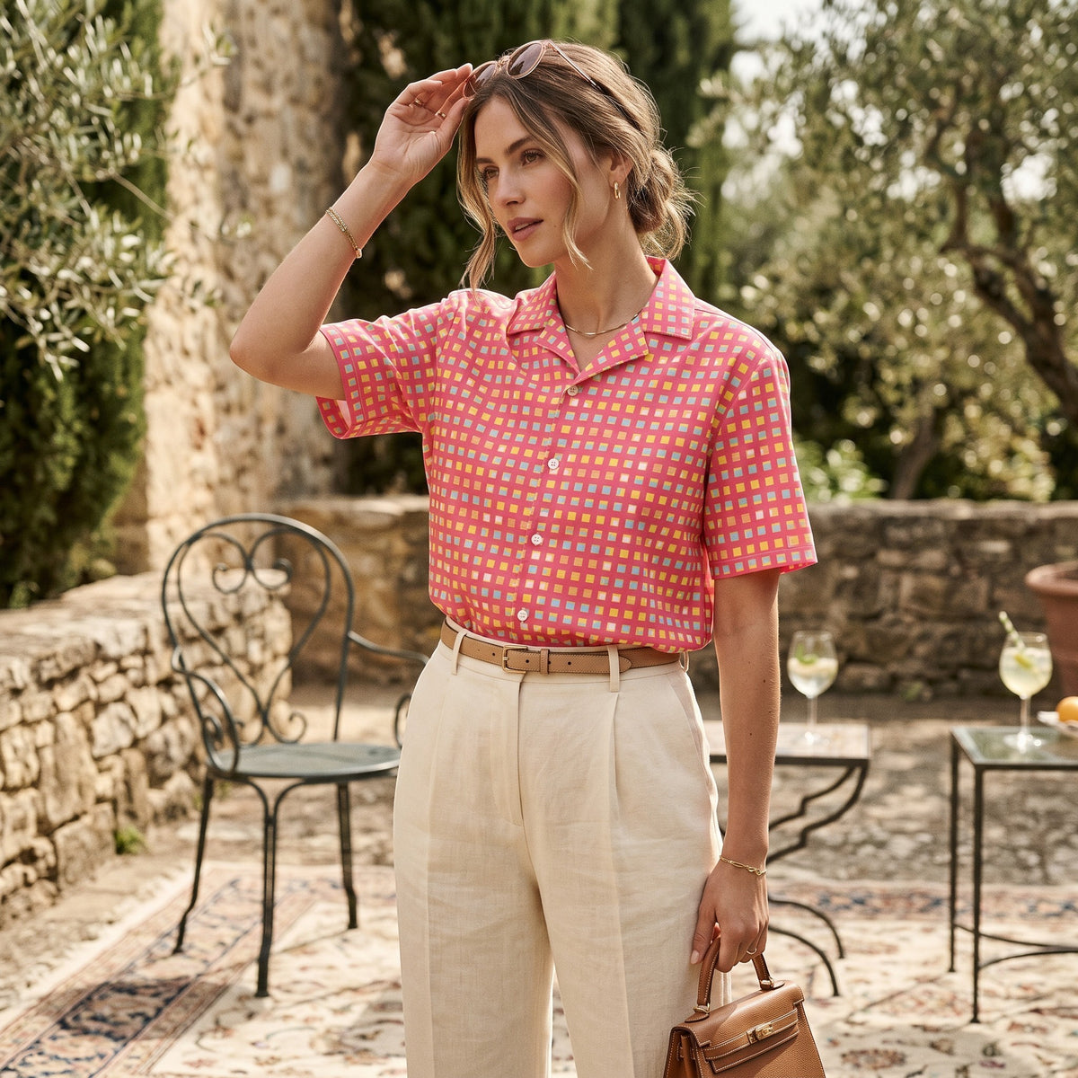 Good Wishes 365 women's pink checkered UPF 50+ button-down shirt with short sleeves, worn with beige linen trousers.