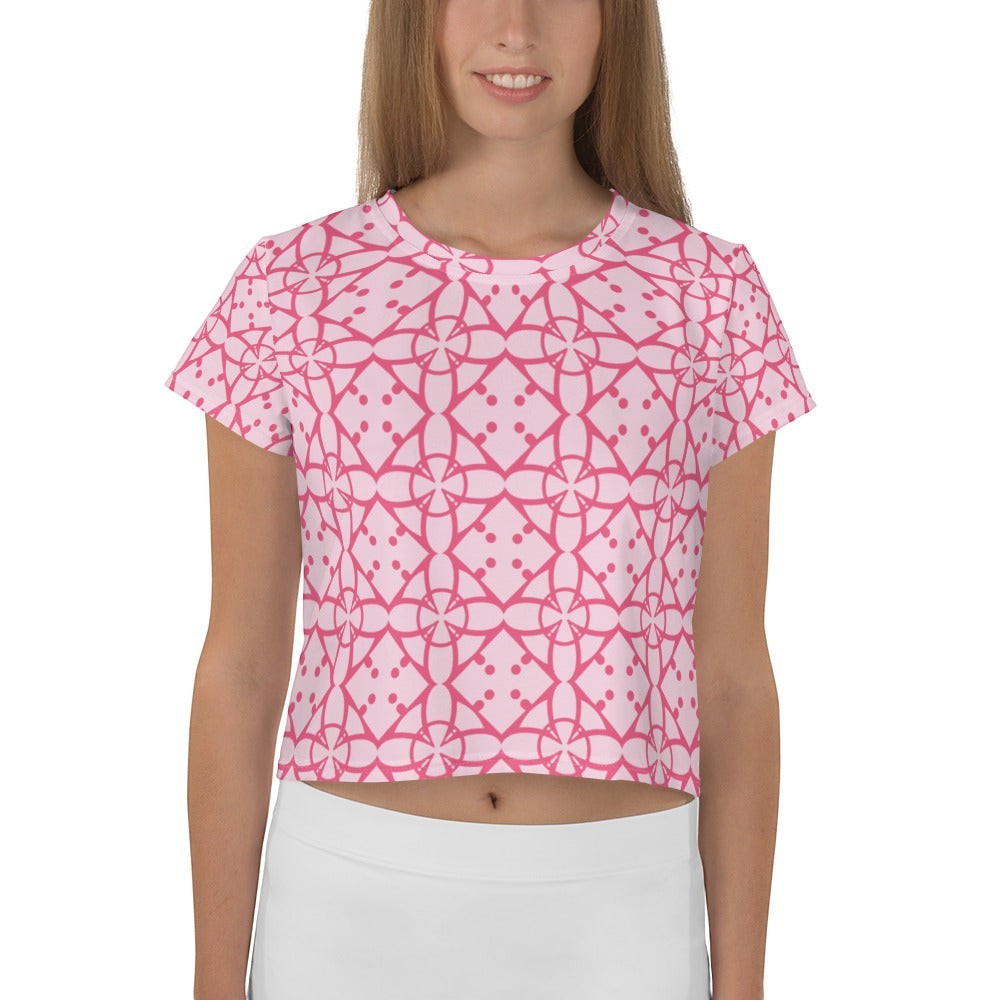 Good Wishes 365 pink geometric print short sleeve crop tee worn by a woman with white high-waisted bottoms.