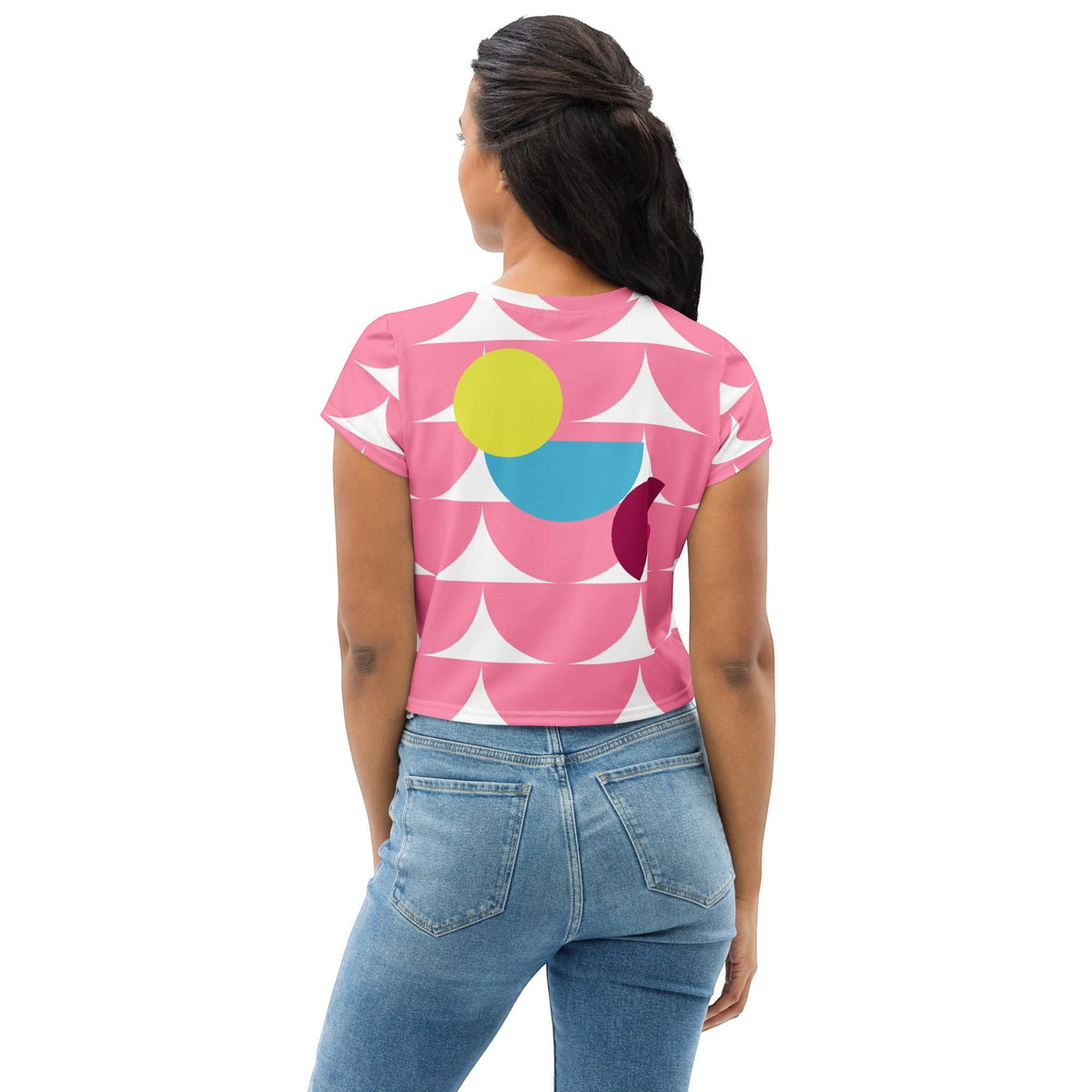 Good Wishes 365 pink crop tee with geometric mushroom pattern worn by a woman with blue jeans, back view.