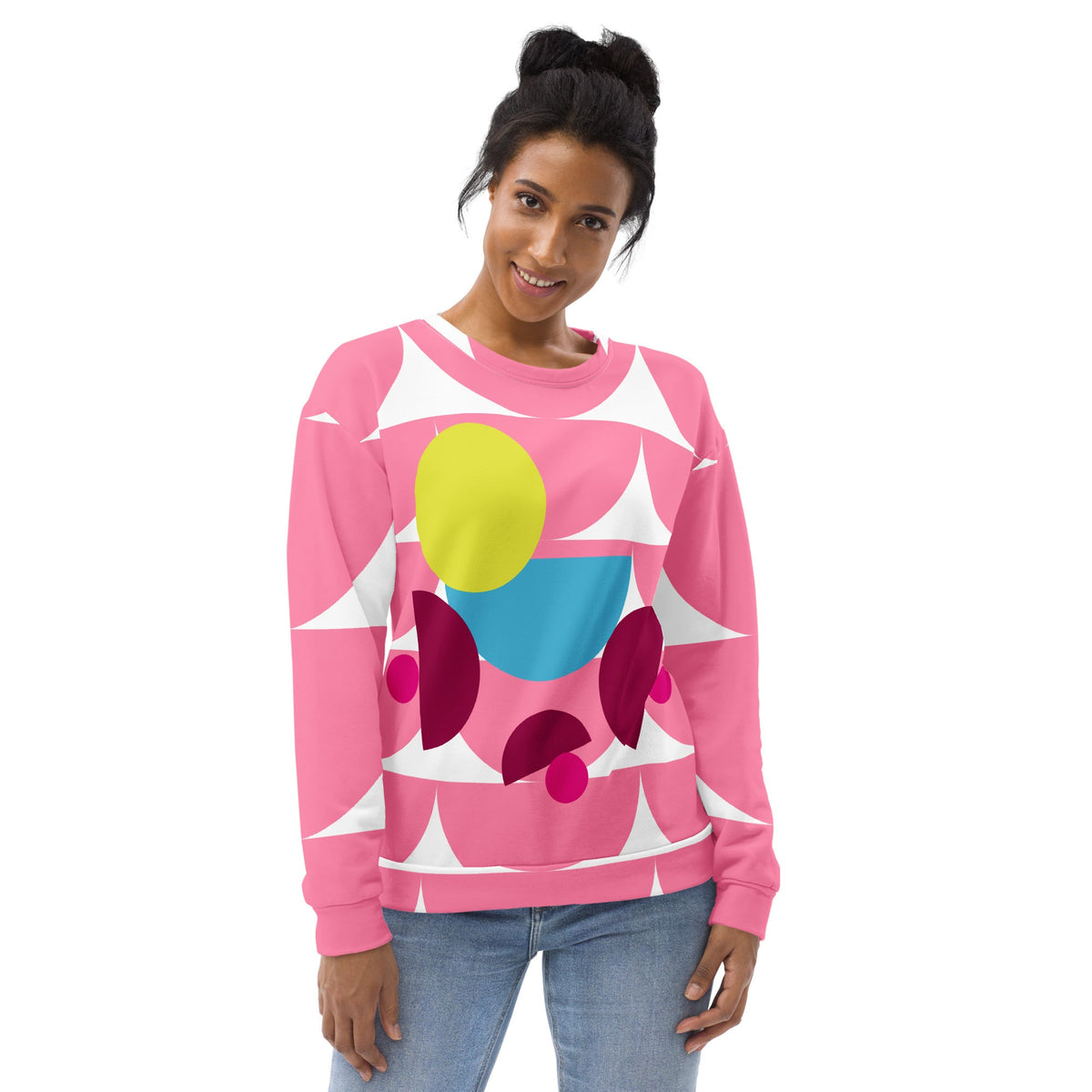 Model wearing a Good Wishes 365 pink recycled sweatshirt with a vibrant geometric mushroom graphic print.