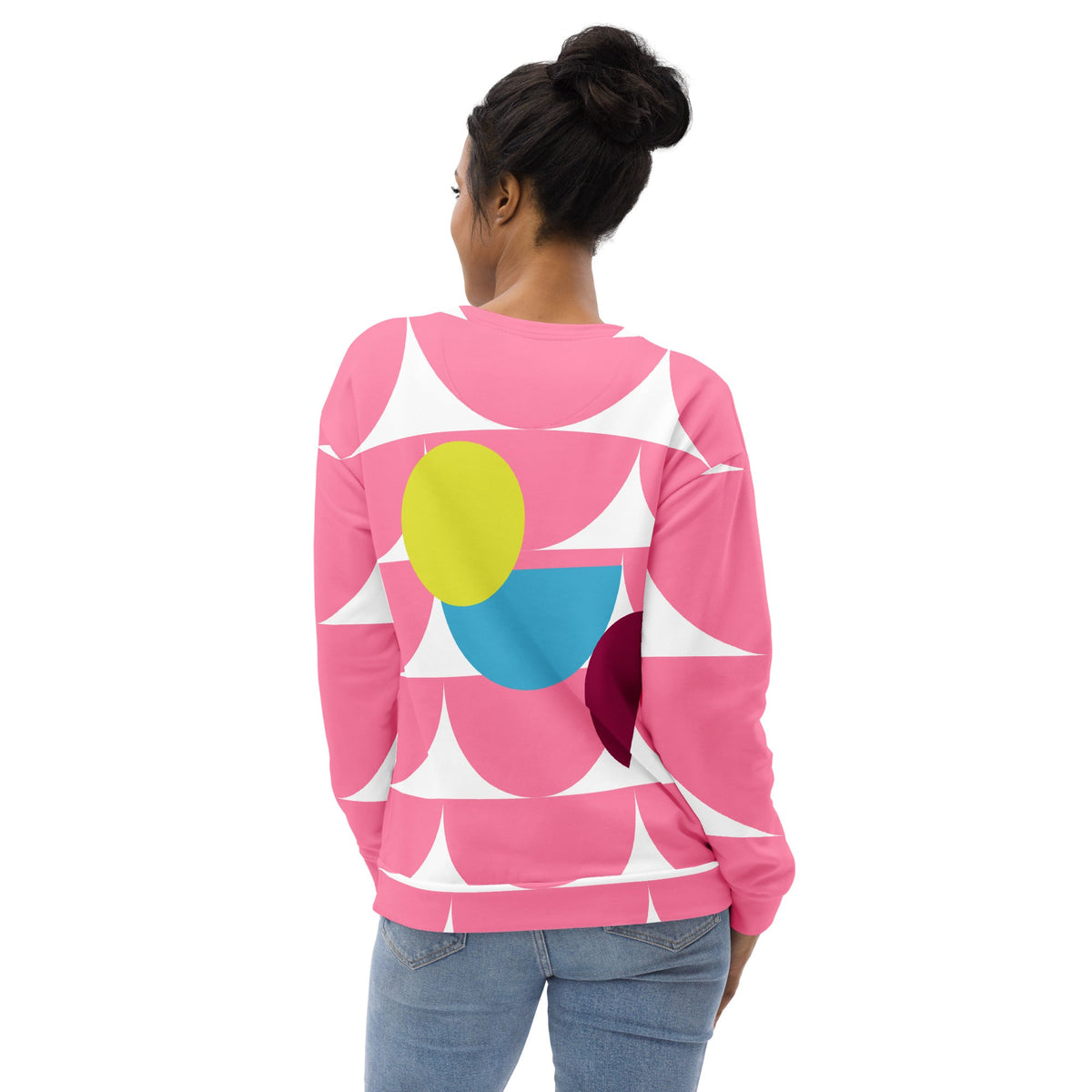 Model wearing a Good Wishes 365 pink recycled sweatshirt with a geometric mushroom graphic print, back view.