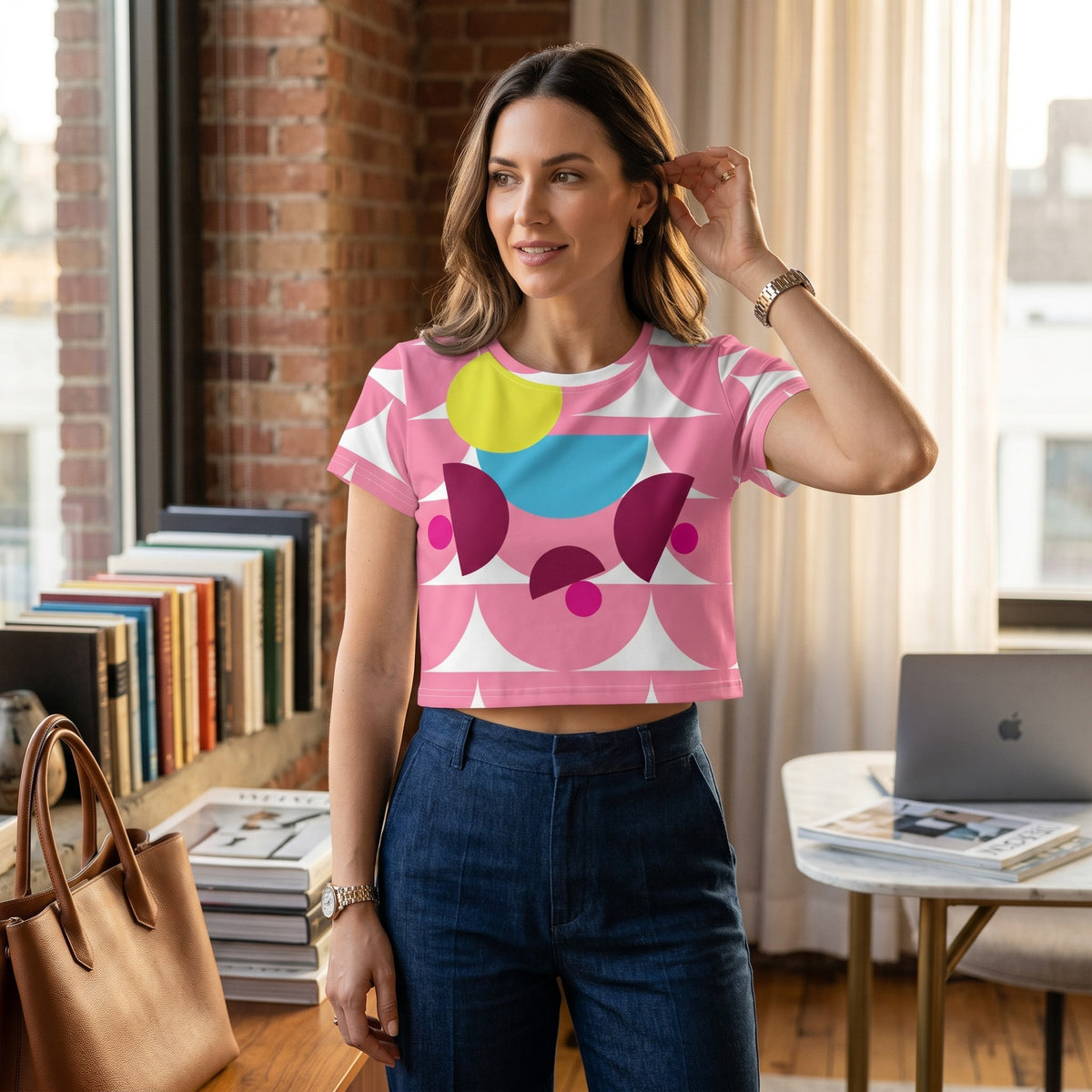 Good Wishes 365 pink crop tee with abstract mushroom pattern worn by a woman in a bright home office setting.