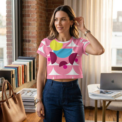 Good Wishes 365 pink crop tee with abstract mushroom pattern worn by a woman in a bright home office setting.