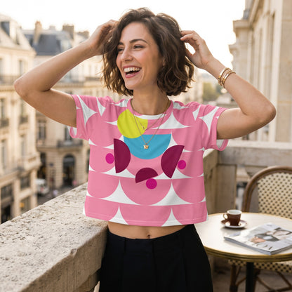 Good Wishes 365 pink crop tee with mushroom pattern worn by a smiling woman on a balcony